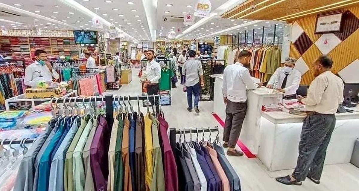 Shoppers walking past closed shutters of a Dhaka market operating under the restored 11am-8pm schedule
